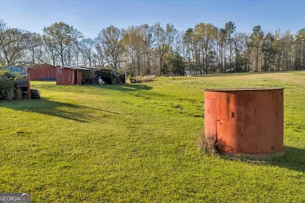 a view of a field with an trees in the background
