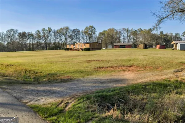 a view of a house with a backyard