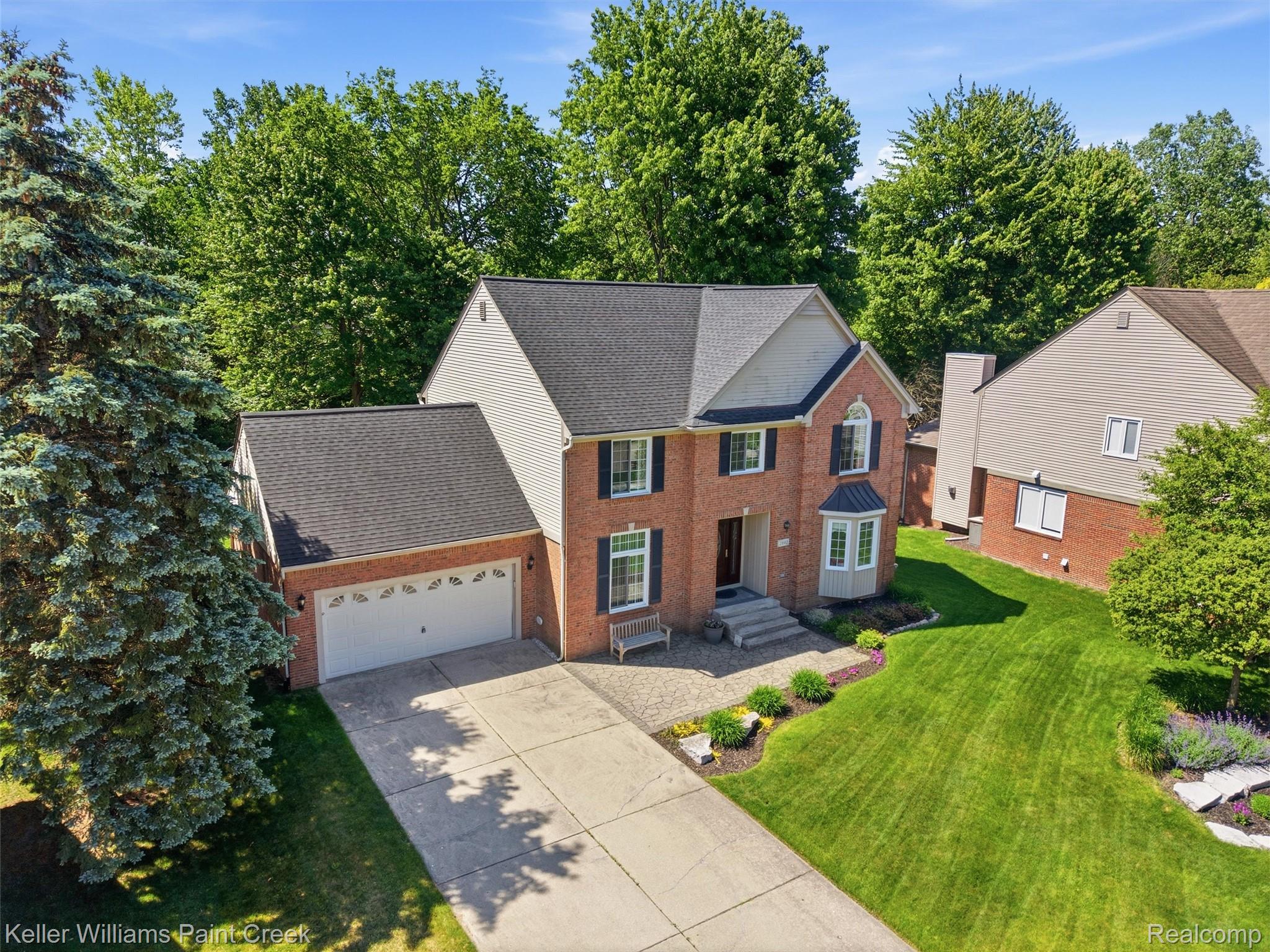 2842 Manorwood Road Troy, MI 48085 - Photo 12 of 72 Brick and siding colonial-style residence featuring a two-car garage, mature landscaping, bay window, and a dark shingle roof