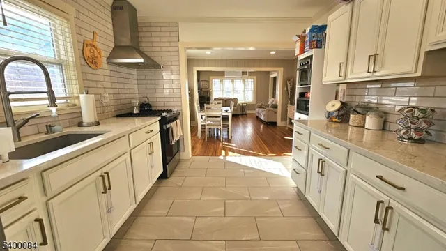 a kitchen with stainless steel appliances granite countertop a sink and cabinets
