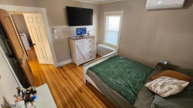 a view of workspace with wooden floor windows and wardrobe