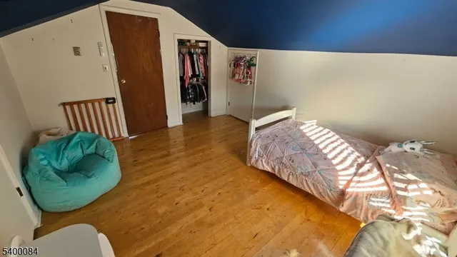 a bedroom with a bed plant and a window