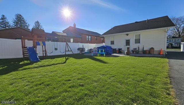 a view of a house with a big yard and sitting area