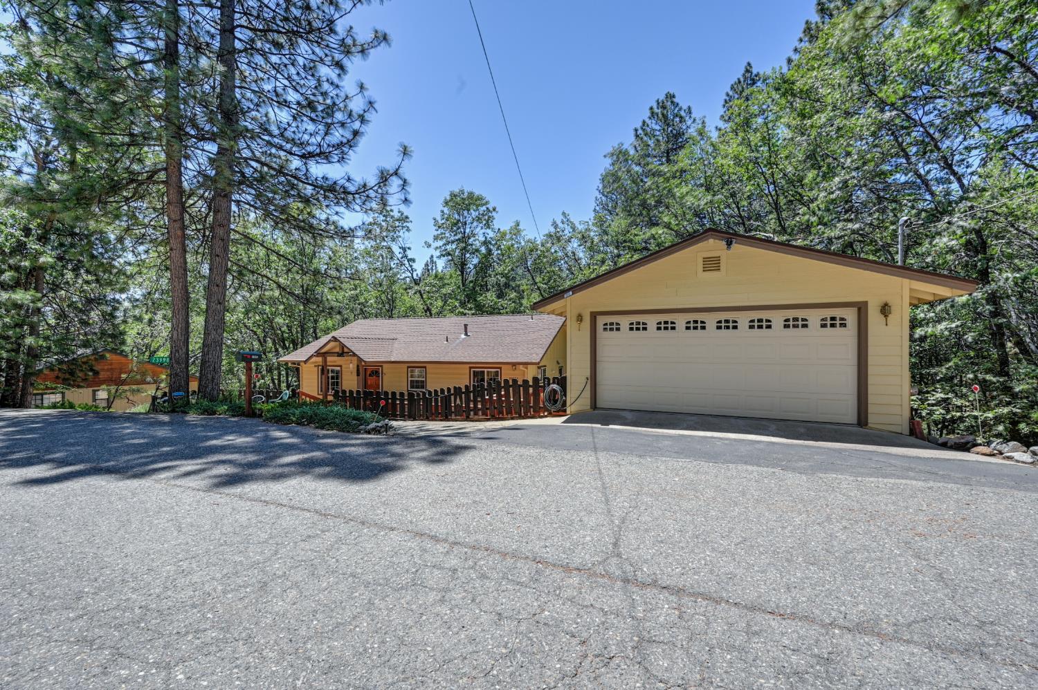23998 Stable Road Sonora, CA 95370 - Photo 25 of 41 a front view of a house with a yard and garage