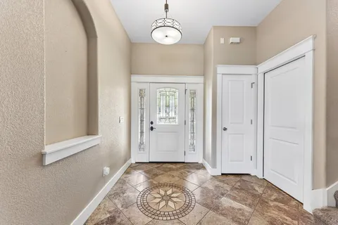 a view of a room with wooden floor and windows