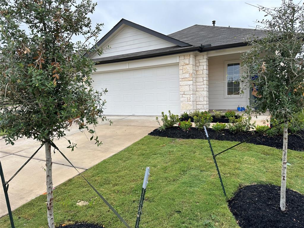 563 Evergreen Sumac Loop Kyle, TX 78640 - Photo 1 of 18 A well-maintained lawn and fresh landscaping enhance this home's inviting facade.