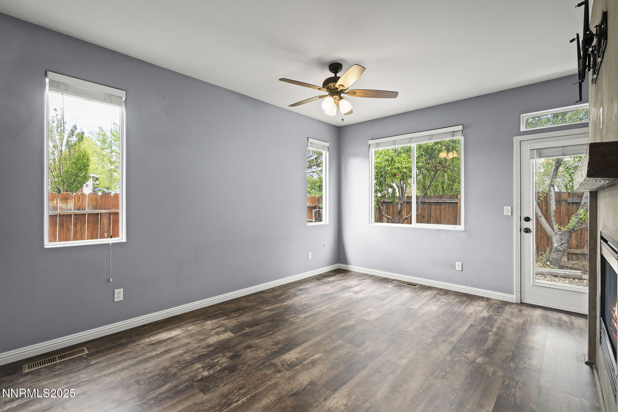 5897 September Circle Reno, NV 89523 - Photo 11 of 24 a view of an empty room with a window and wooden floor