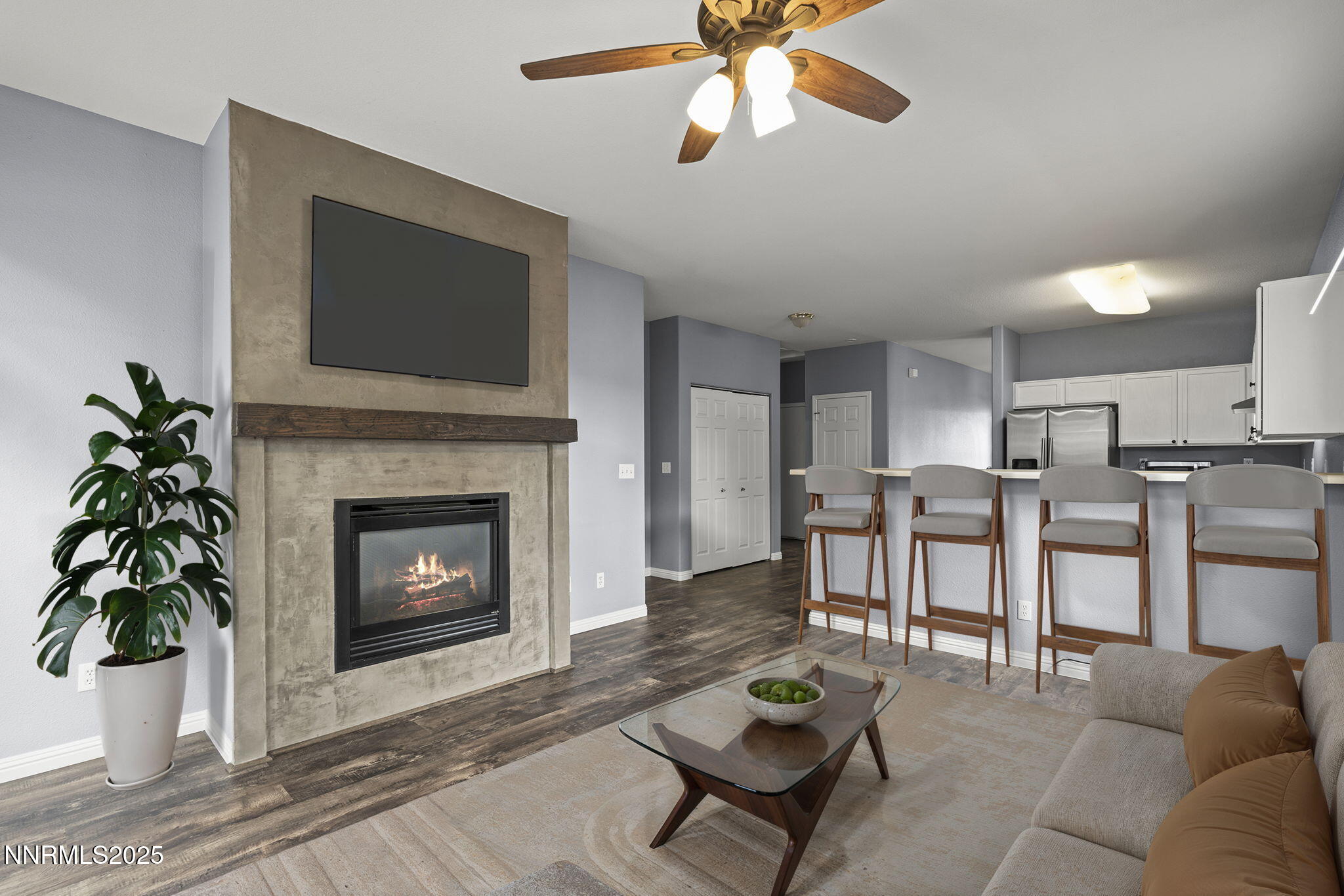 5897 September Circle Reno, NV 89523 - Photo 12 of 24 a living room with furniture a fireplace and a flat screen tv