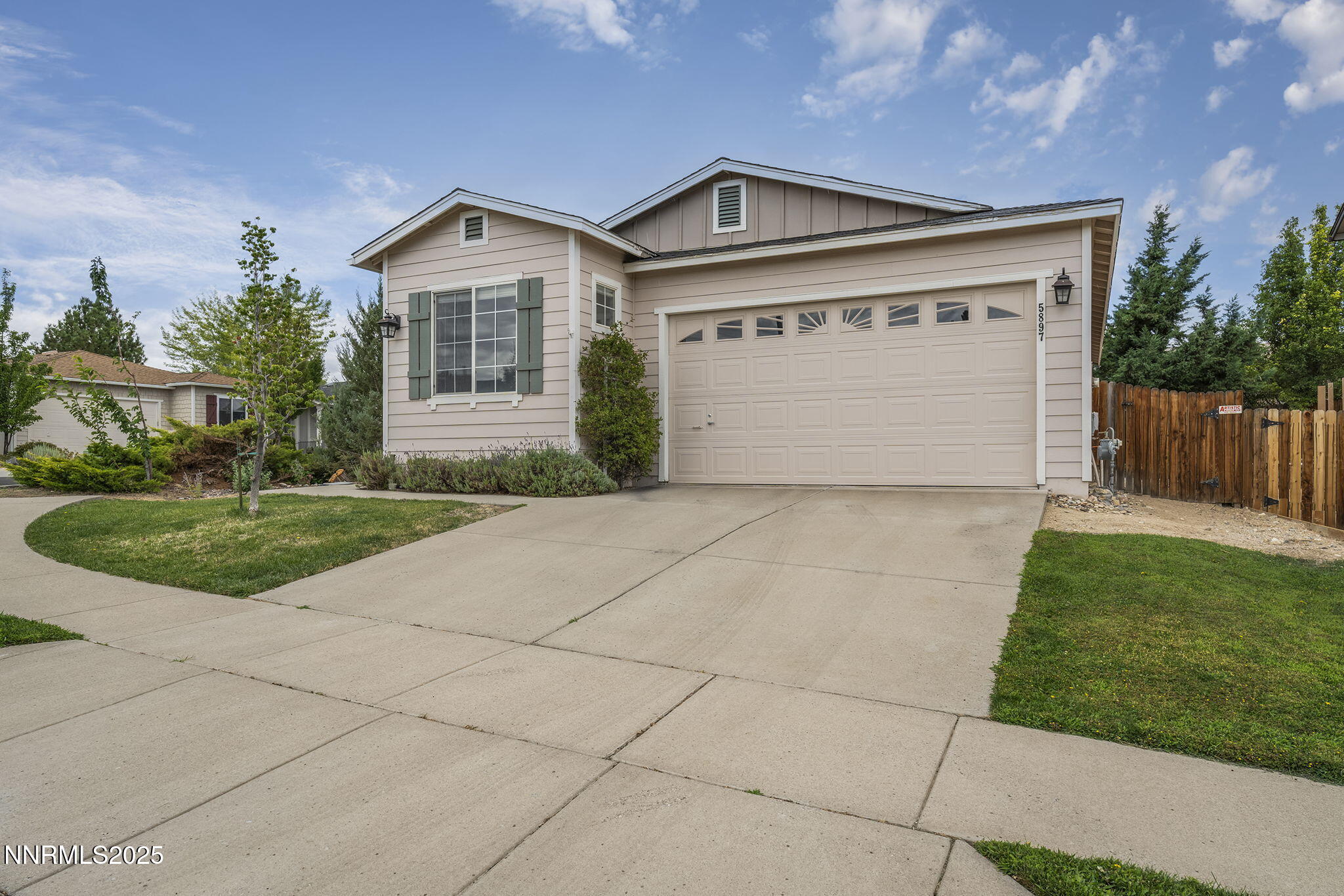5897 September Circle Reno, NV 89523 - Photo 2 of 24 a front view of a house with a yard and garage