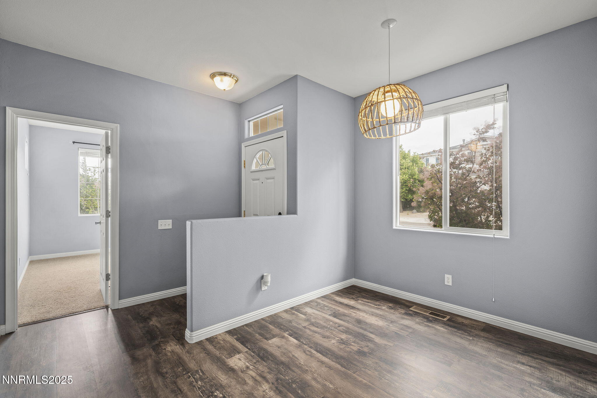 5897 September Circle Reno, NV 89523 - Photo 6 of 24 an empty room with wooden floor fan and windows