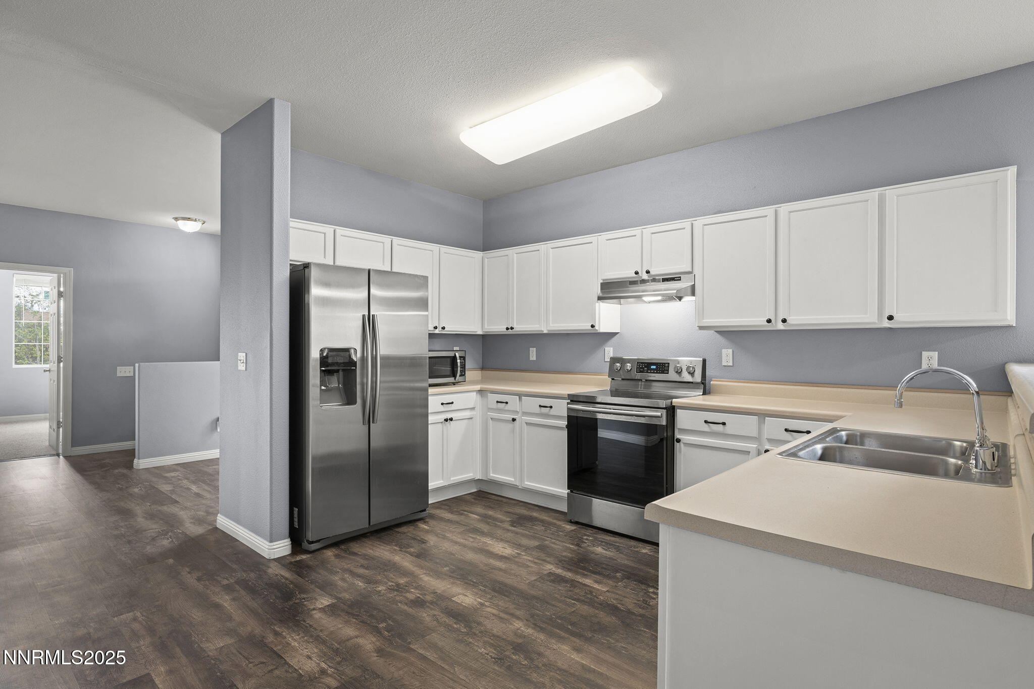 5897 September Circle Reno, NV 89523 - Photo 8 of 24 a kitchen with a refrigerator sink and cabinets