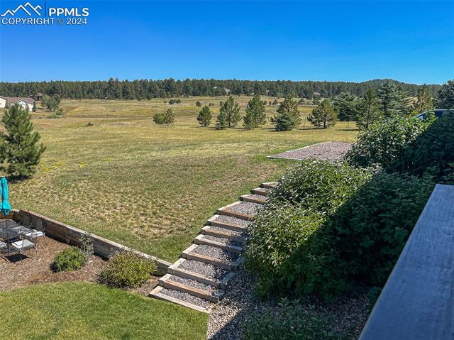19535 Yellow Wing Court Colorado Springs, CO 80908 - Photo 8 of 8 Stairs leading from front to back of the home