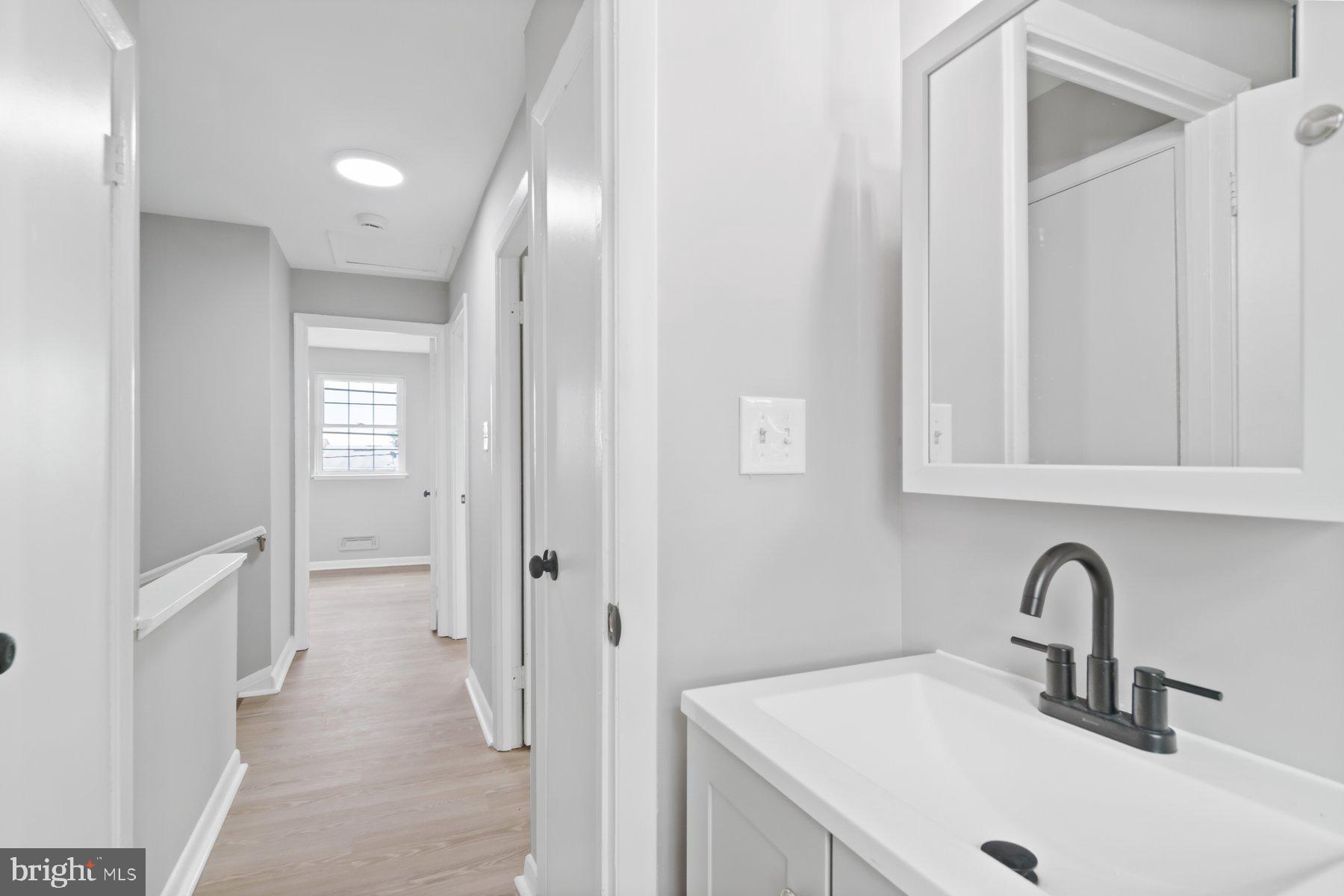 653 Charraway Road Baltimore, MD 21229 - Photo 19 of 27 a bathroom with a sink and mirror