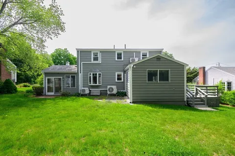 a view of a house with a yard and sitting area