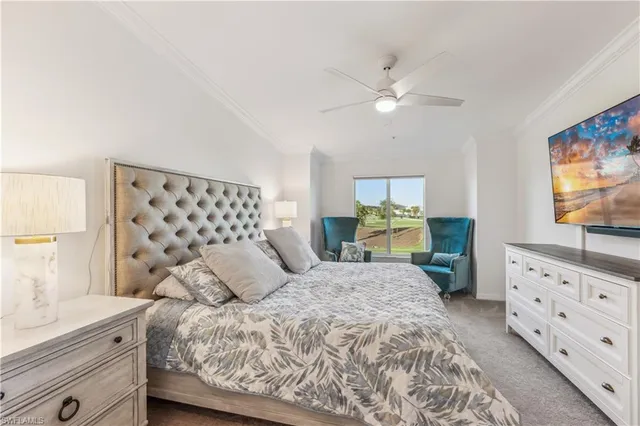 a bedroom with a bed and a flat tv screen on dresser