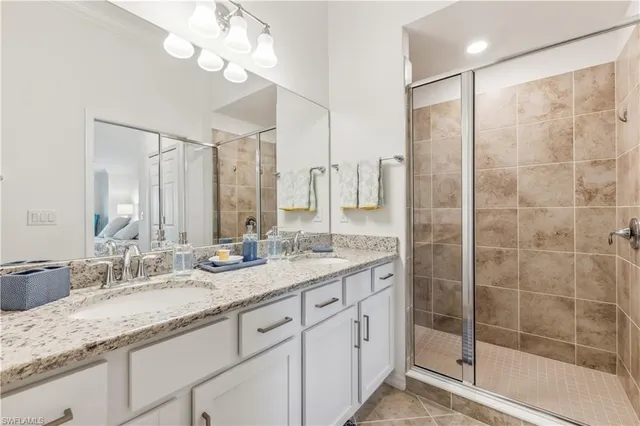 a bathroom with a granite countertop sink mirror and double