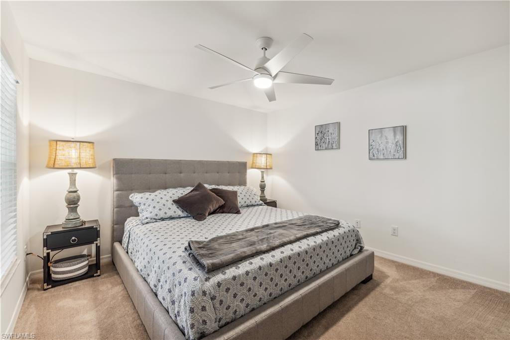 43051 Greenway Boulevard, Unit 822 Babcock Ranch, FL 33982 - Photo 13 of 16 a bedroom with a bed and a lamp