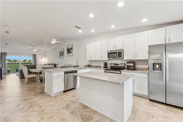 a kitchen with a sink stainless steel appliances and cabinets