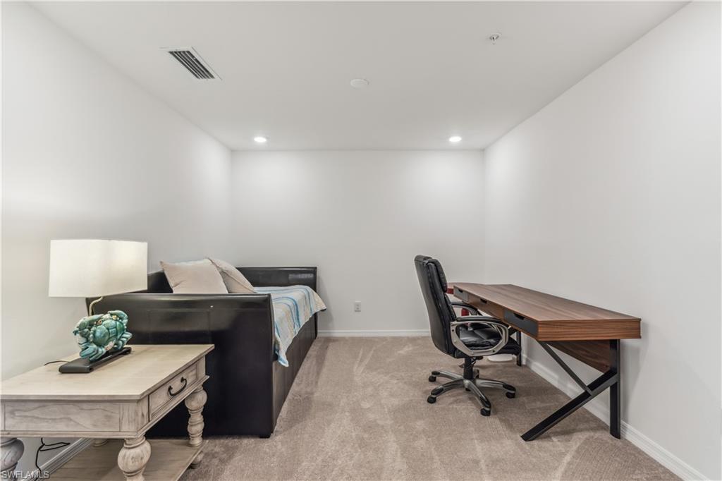 43051 Greenway Boulevard, Unit 822 Babcock Ranch, FL 33982 - Photo 9 of 16 a workspace with furniture and wooden floor