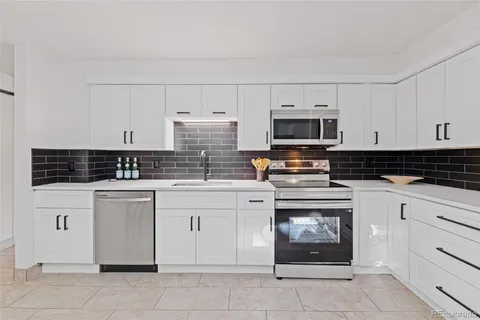a kitchen with cabinets appliances and a window