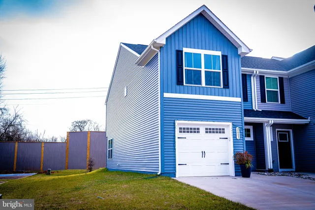 a view of a house with wooden fence