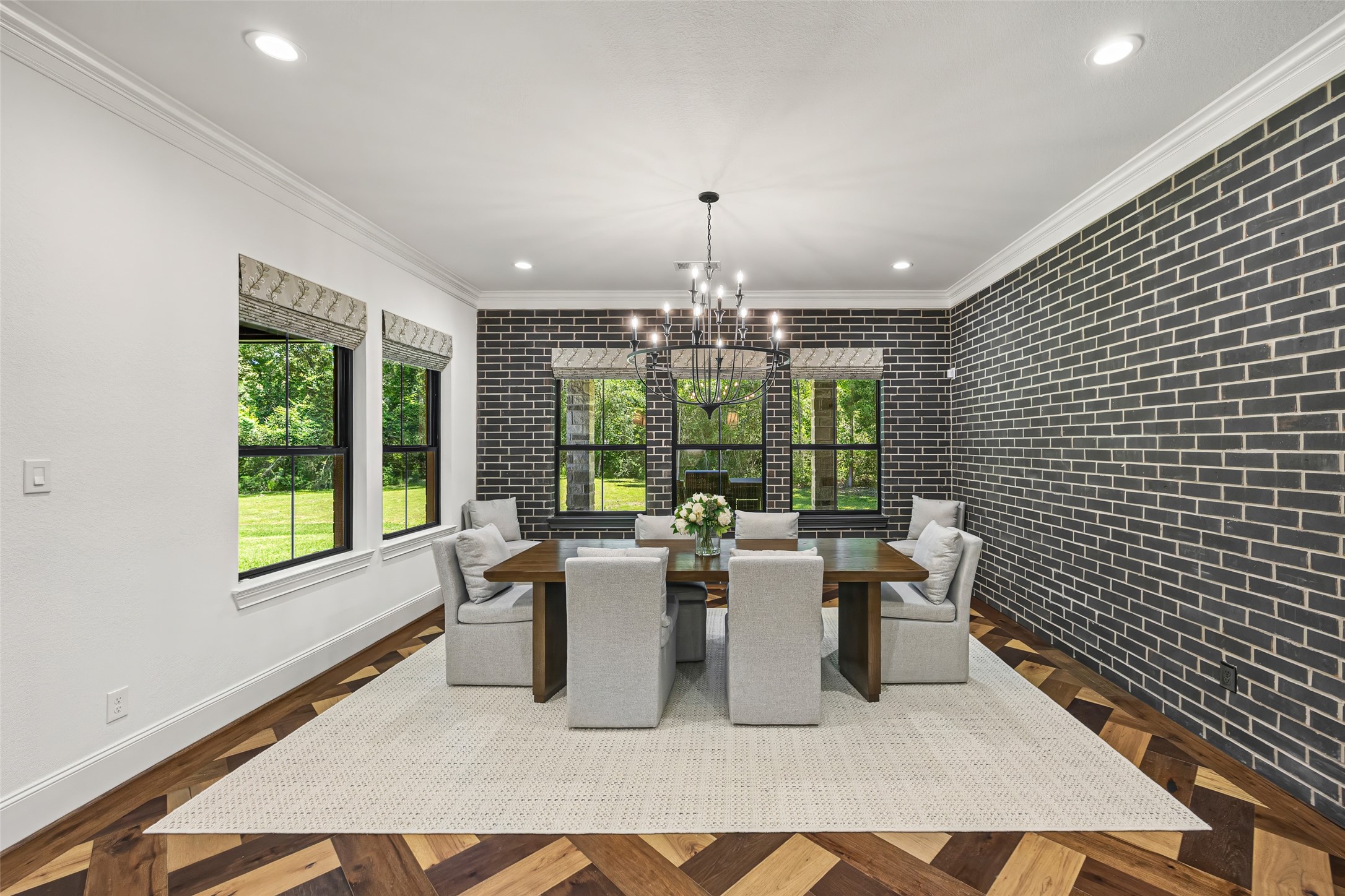 19314 Chateau Ridge Court Tomball, TX 77377 - Photo 12 of 50 Beautiful, exquisitely designed dining room featuring a rich brick accent wall and a warm, sophisticated ambiance.