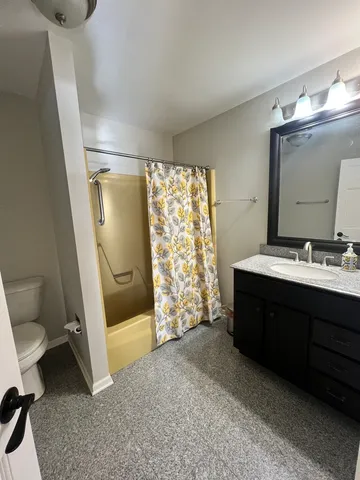 a spacious bathroom with a double vanity sink toilet and shower
