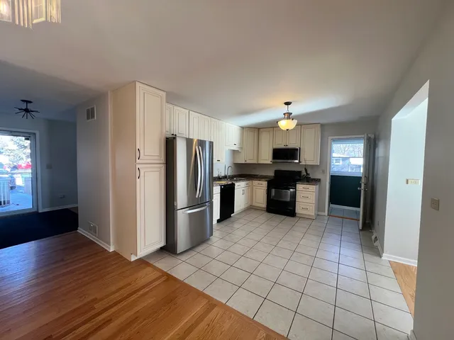 a kitchen with stainless steel appliances granite countertop a refrigerator and a stove top oven