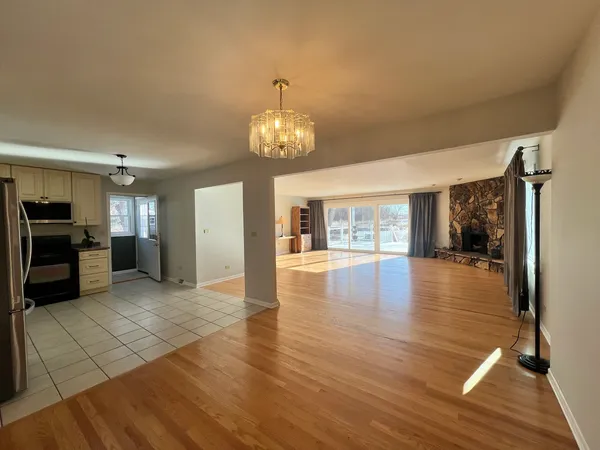 a view of a room with kitchen and windows