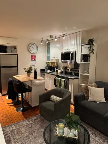 a living room with furniture and kitchen view