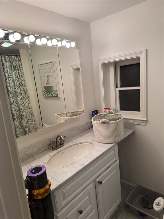 1914 Washington Street, Unit 4 Boston, MA 02118 - Photo 7 of 11 a bathroom with a sink and a mirror