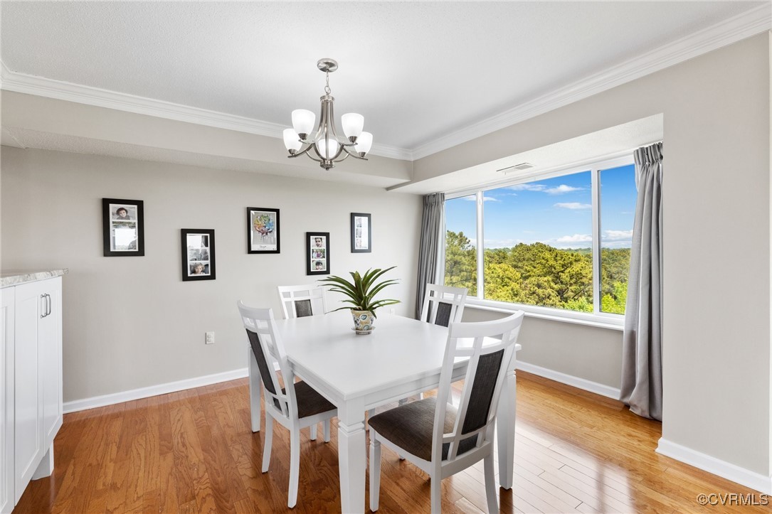 2956 Hathaway Road, Unit U912 Richmond, VA 23225 - Photo 6 of 29 a view of a dining room with furniture a chandelier and wooden floor