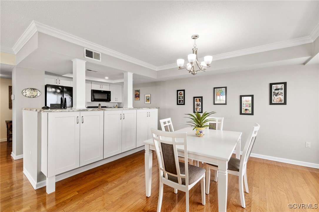 2956 Hathaway Road, Unit U912 Richmond, VA 23225 - Photo 7 of 29 a dining room with furniture and chandelier