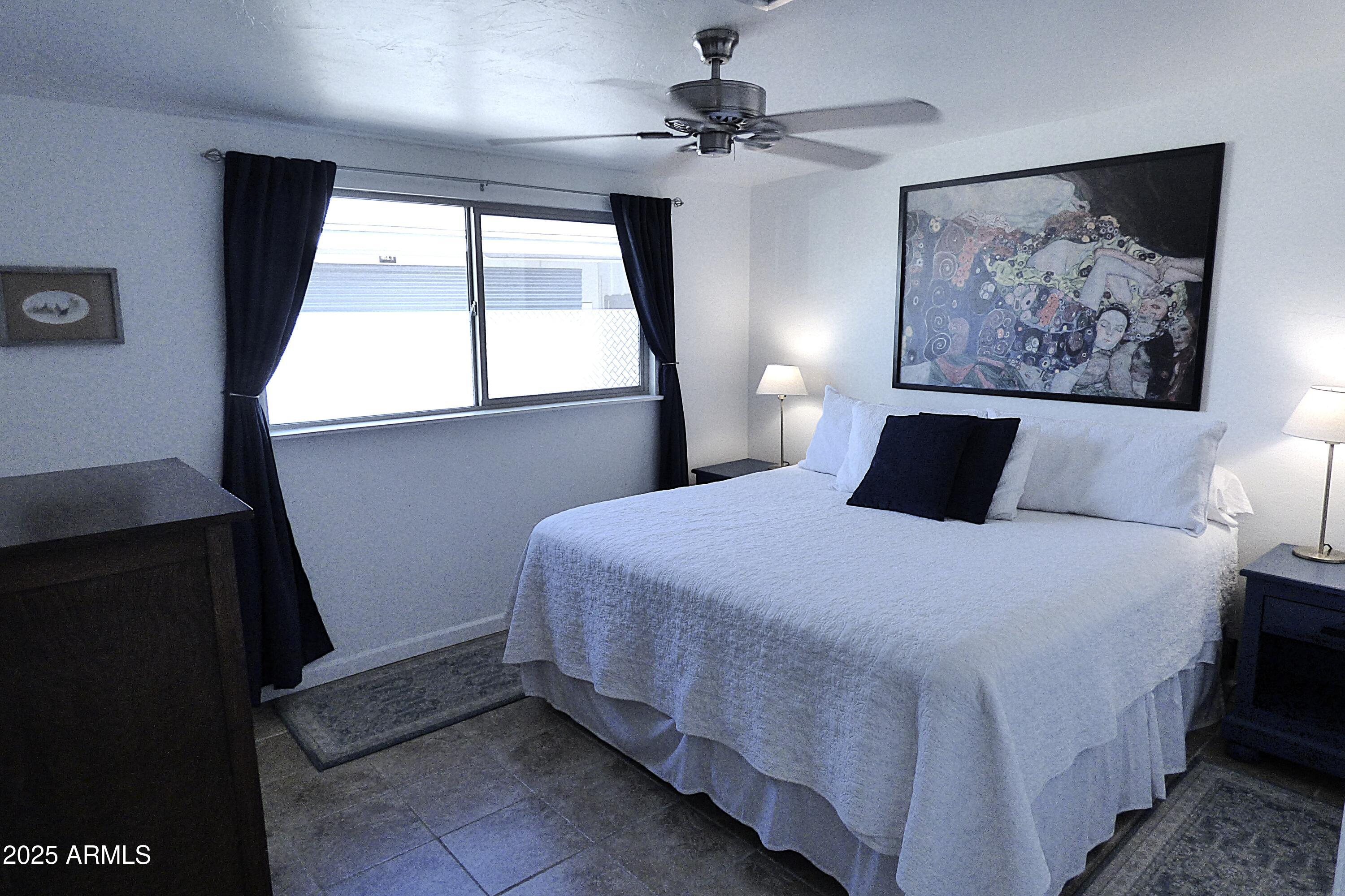 6700 East Thomas Road, Unit 34 Scottsdale, AZ 85251 - Photo 11 of 69 a bedroom with a bed and a painting on the wall