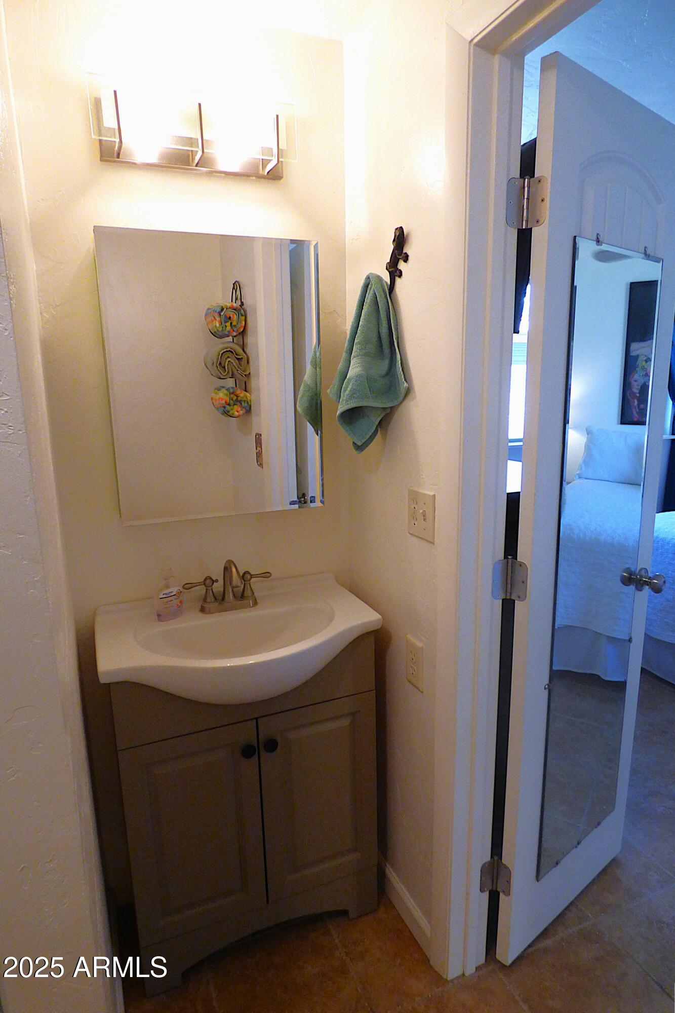 6700 East Thomas Road, Unit 34 Scottsdale, AZ 85251 - Photo 15 of 69 a bathroom with a sink and mirror