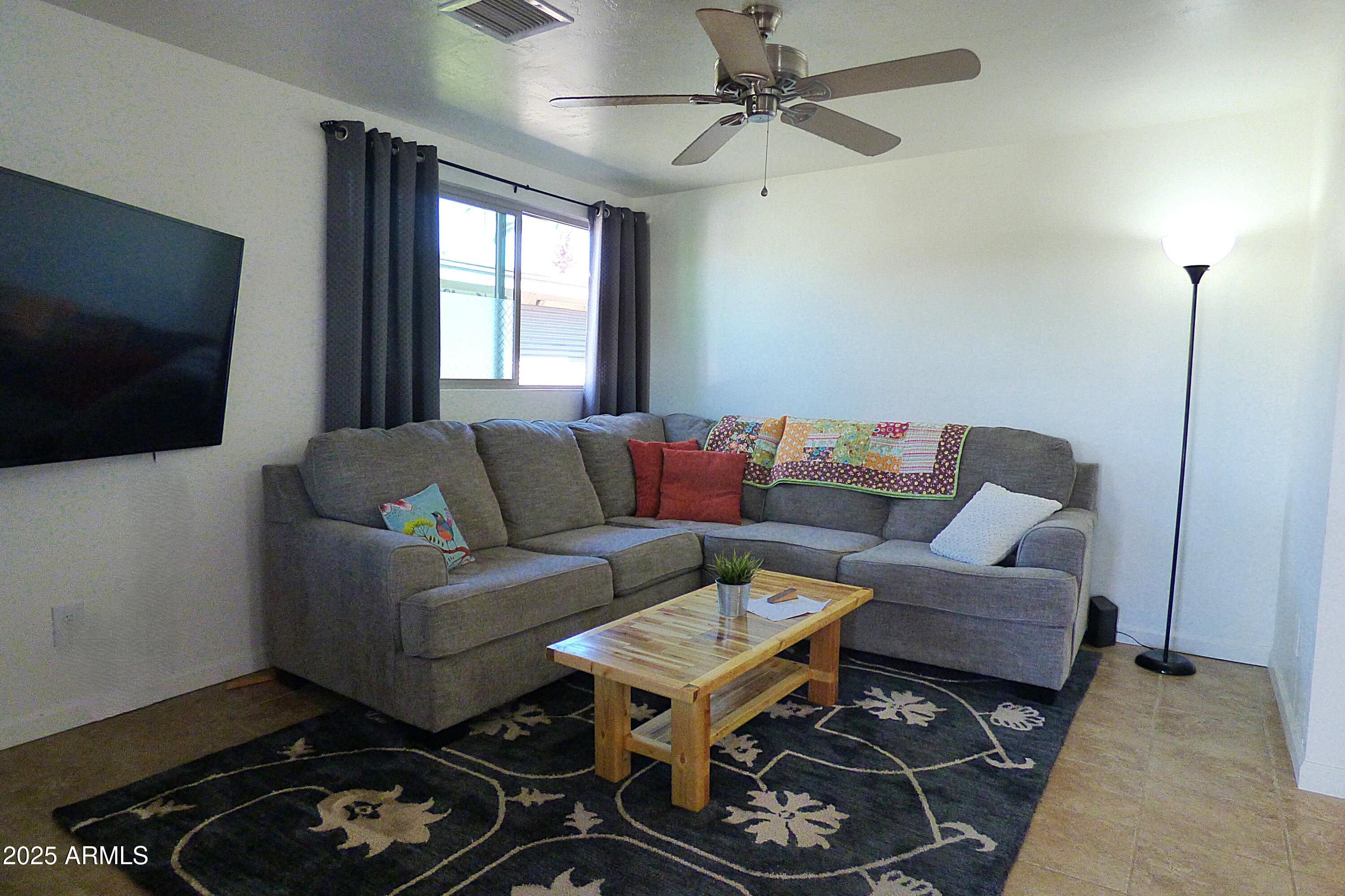 6700 East Thomas Road, Unit 34 Scottsdale, AZ 85251 - Photo 17 of 71 a living room with furniture and a flat screen tv