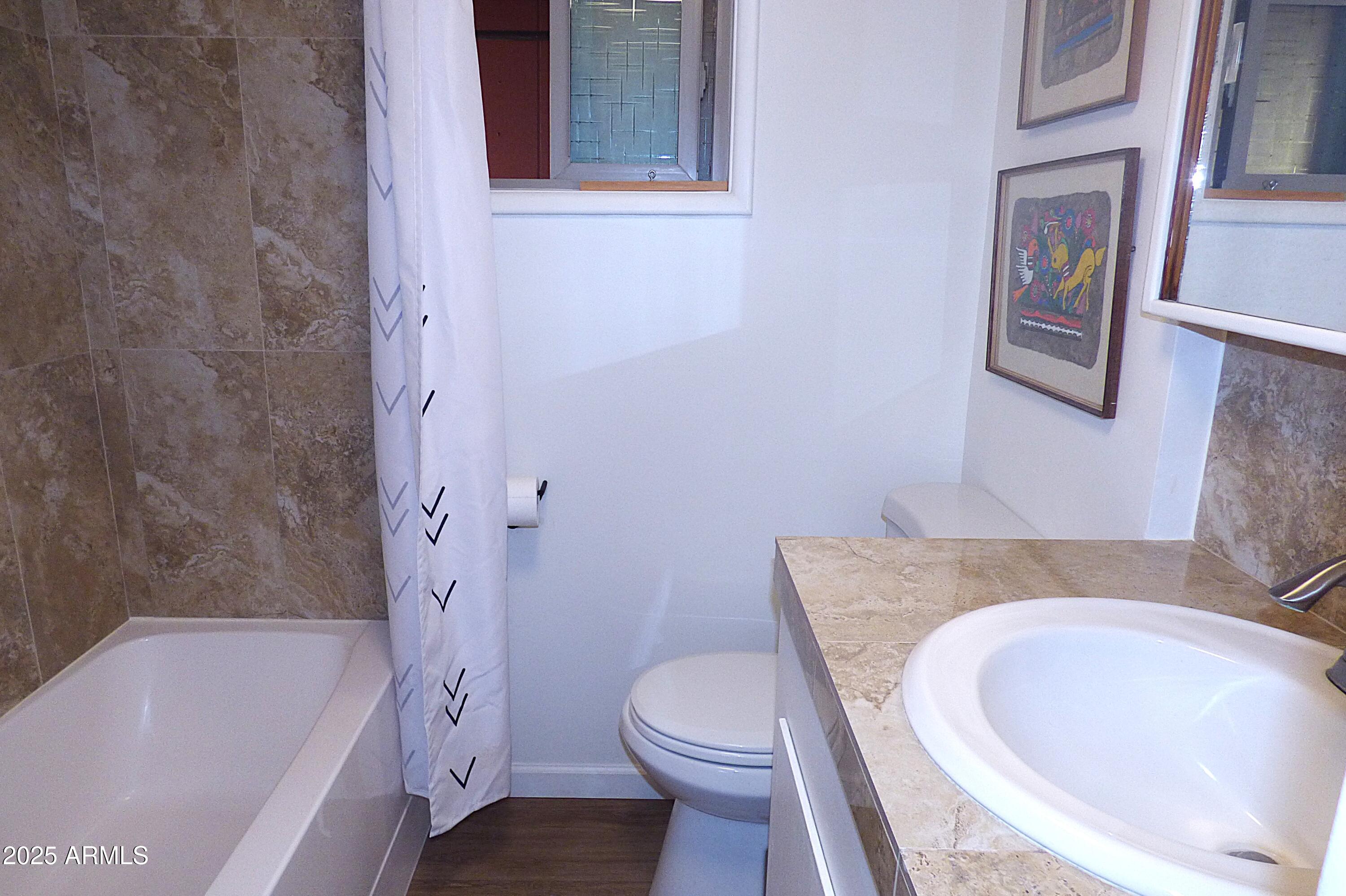 6700 East Thomas Road, Unit 34 Scottsdale, AZ 85251 - Photo 20 of 69 a bathroom with a granite countertop toilet sink and bathtub