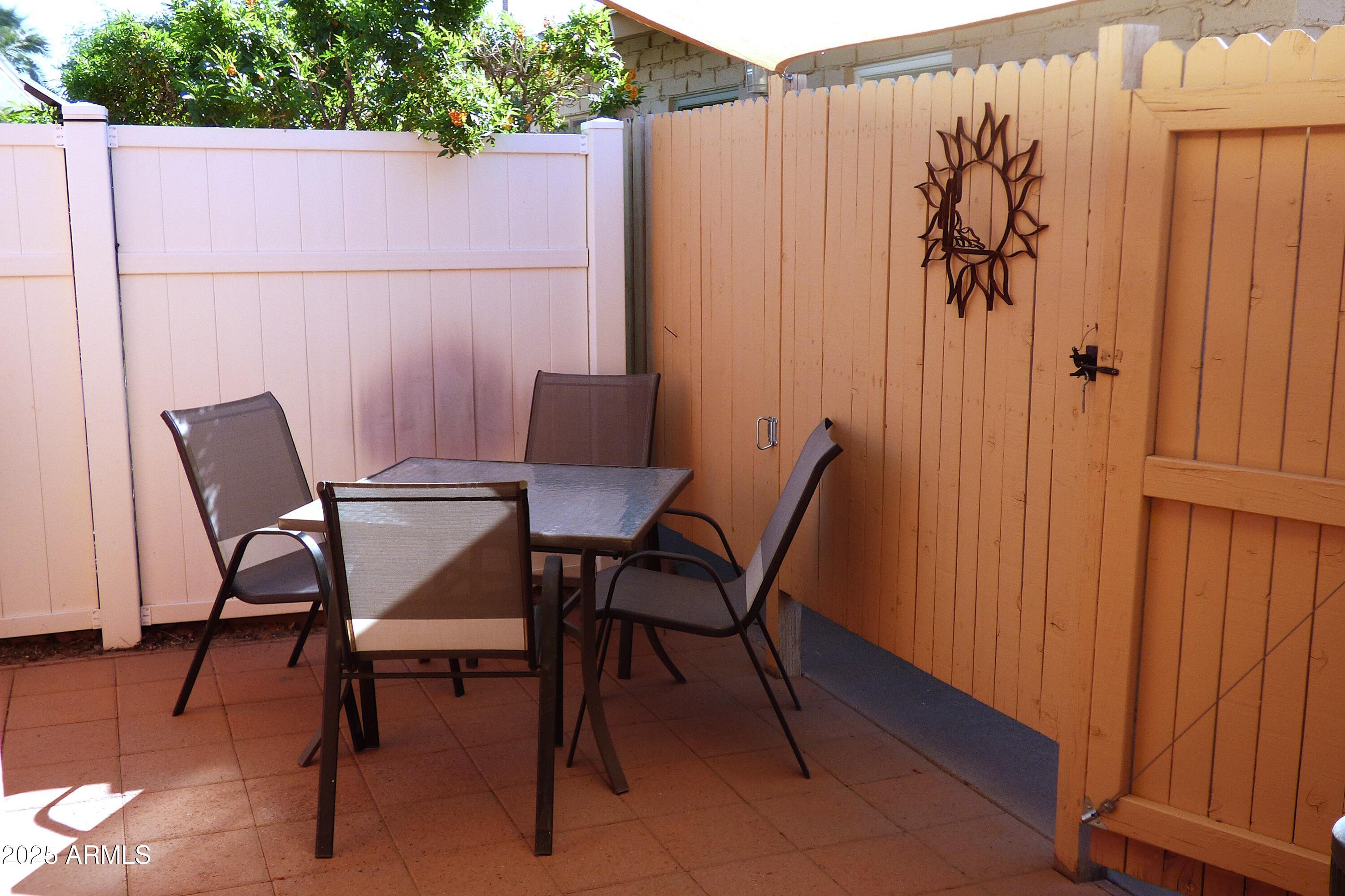 6700 East Thomas Road, Unit 34 Scottsdale, AZ 85251 - Photo 35 of 69 a view of a chairs and table in the back yard of the house