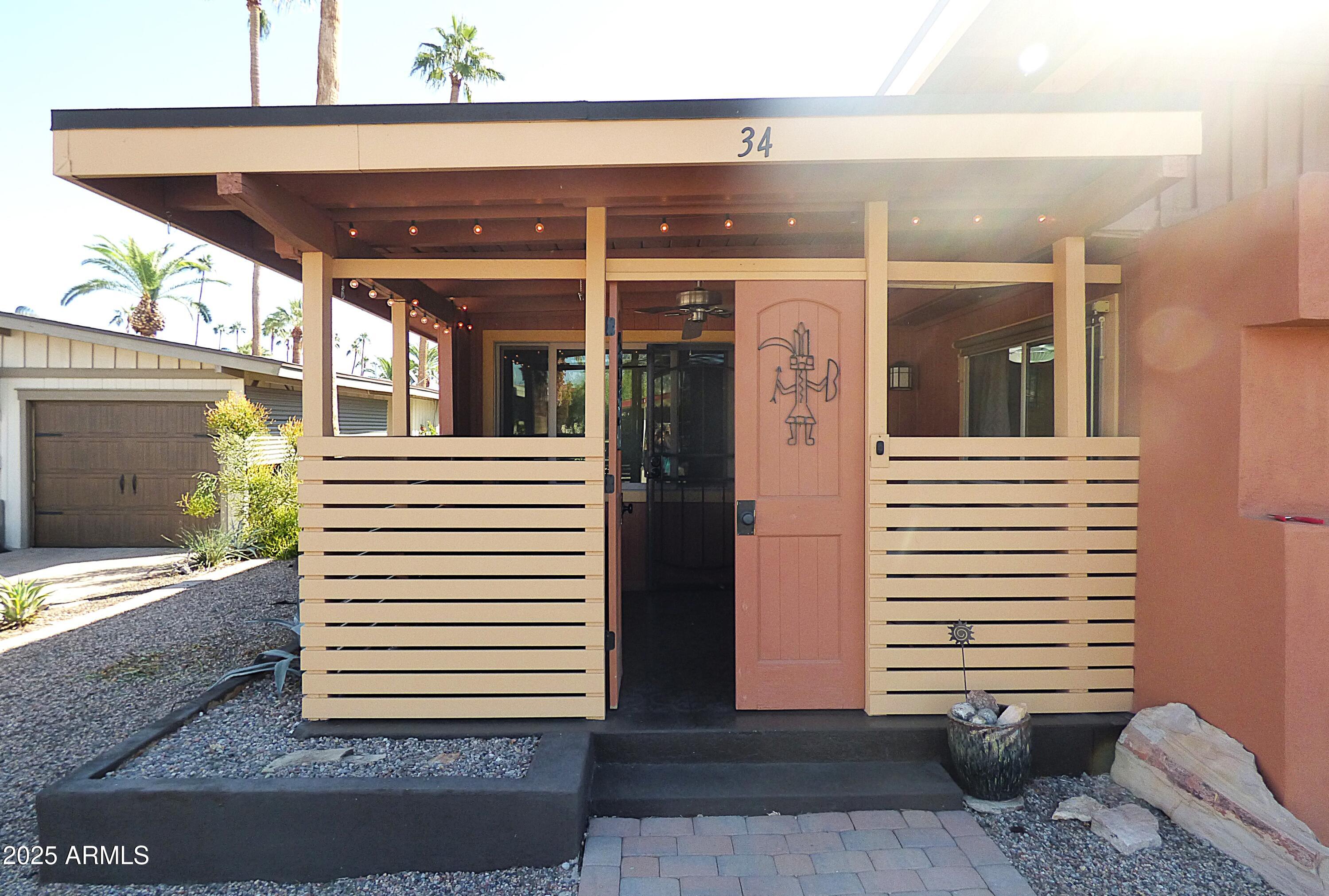 6700 East Thomas Road, Unit 34 Scottsdale, AZ 85251 - Photo 8 of 71 a view of a porch with a door and a yard