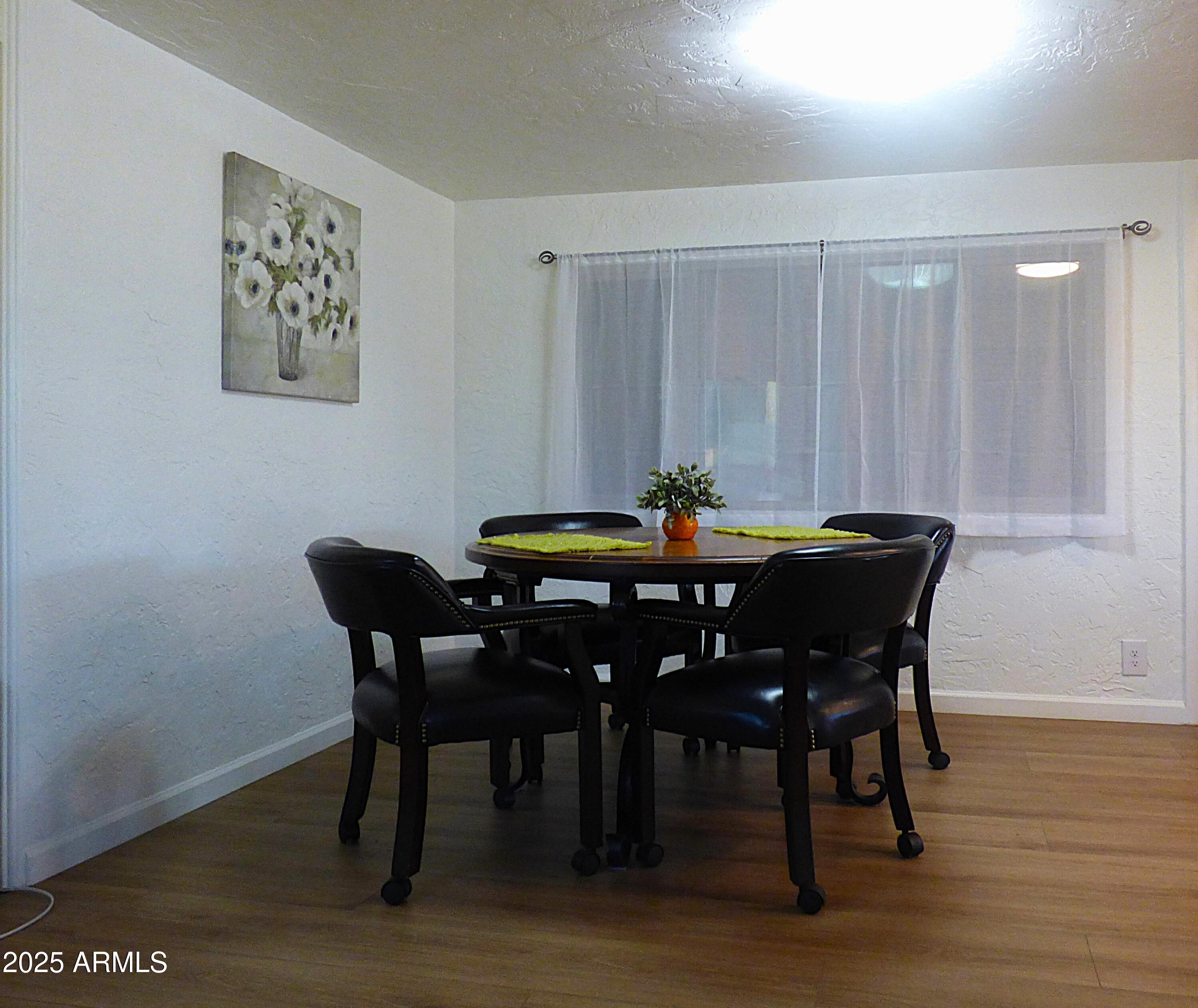 6700 East Thomas Road, Unit 34 Scottsdale, AZ 85251 - Photo 10 of 69 a dining room with furniture and wooden floor