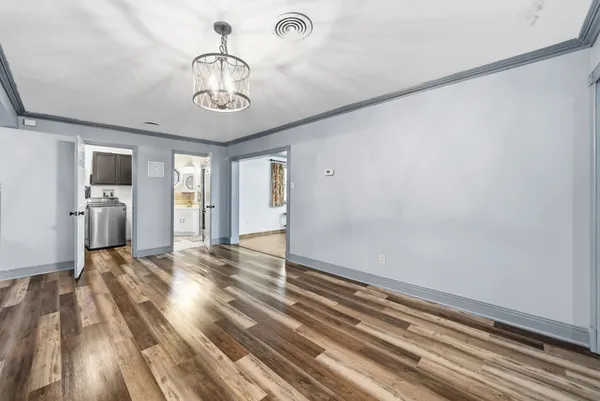 wooden floor in an empty room with a large window