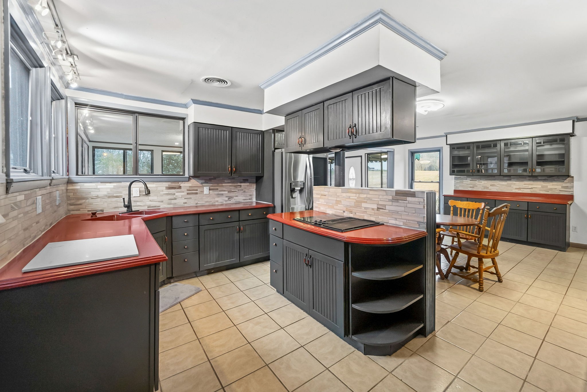369 Holiday Acres Drive Springville, TN 38256 - Photo 20 of 100 a kitchen with stainless steel appliances granite countertop a stove a sink and a refrigerator