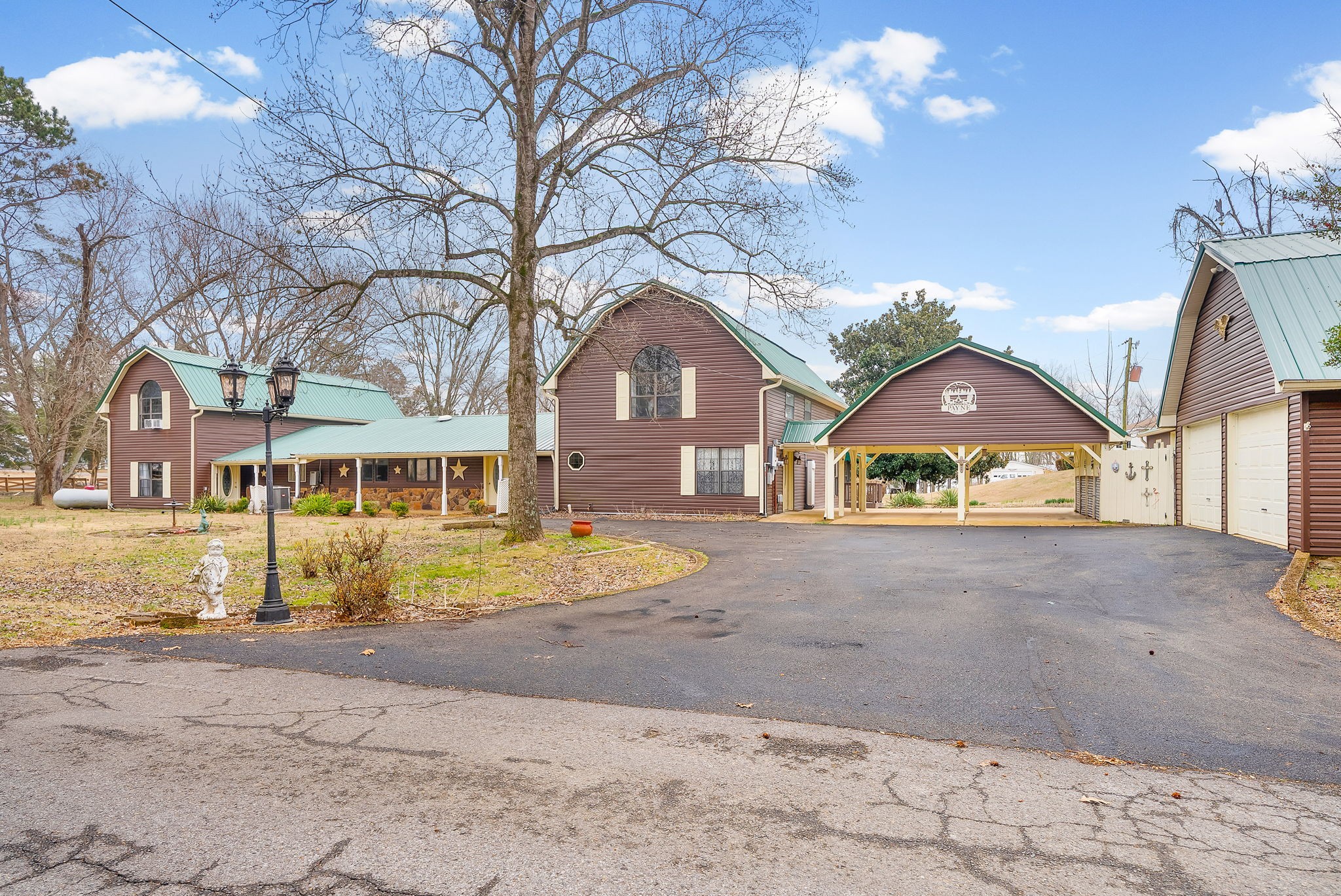 369 Holiday Acres Drive Springville, TN 38256 - Photo 5 of 100 a front view of a house with a yard and garage