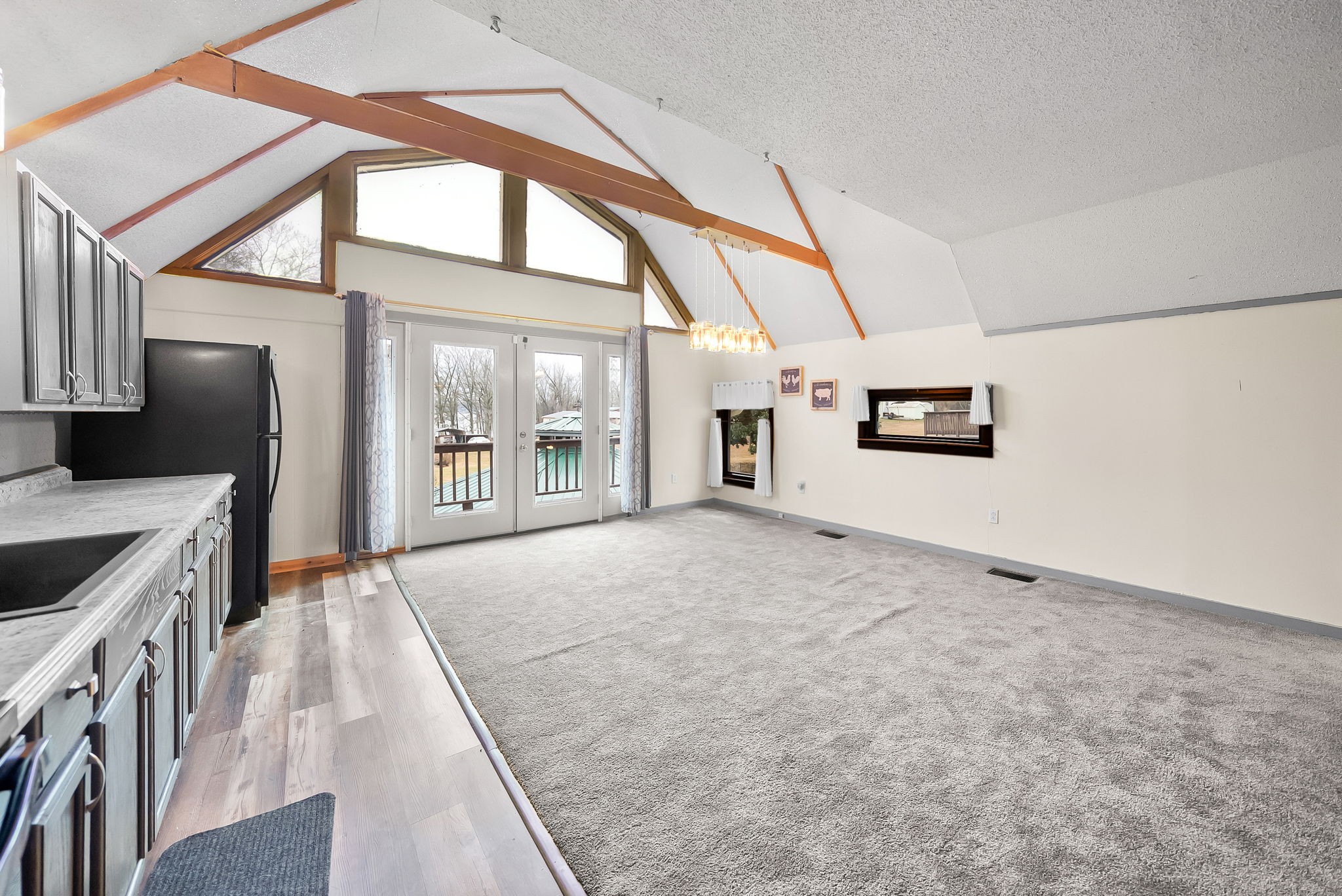 369 Holiday Acres Drive Springville, TN 38256 - Photo 52 of 100 a view of a kitchen with a sink and dishwasher a stove top oven with wooden floor