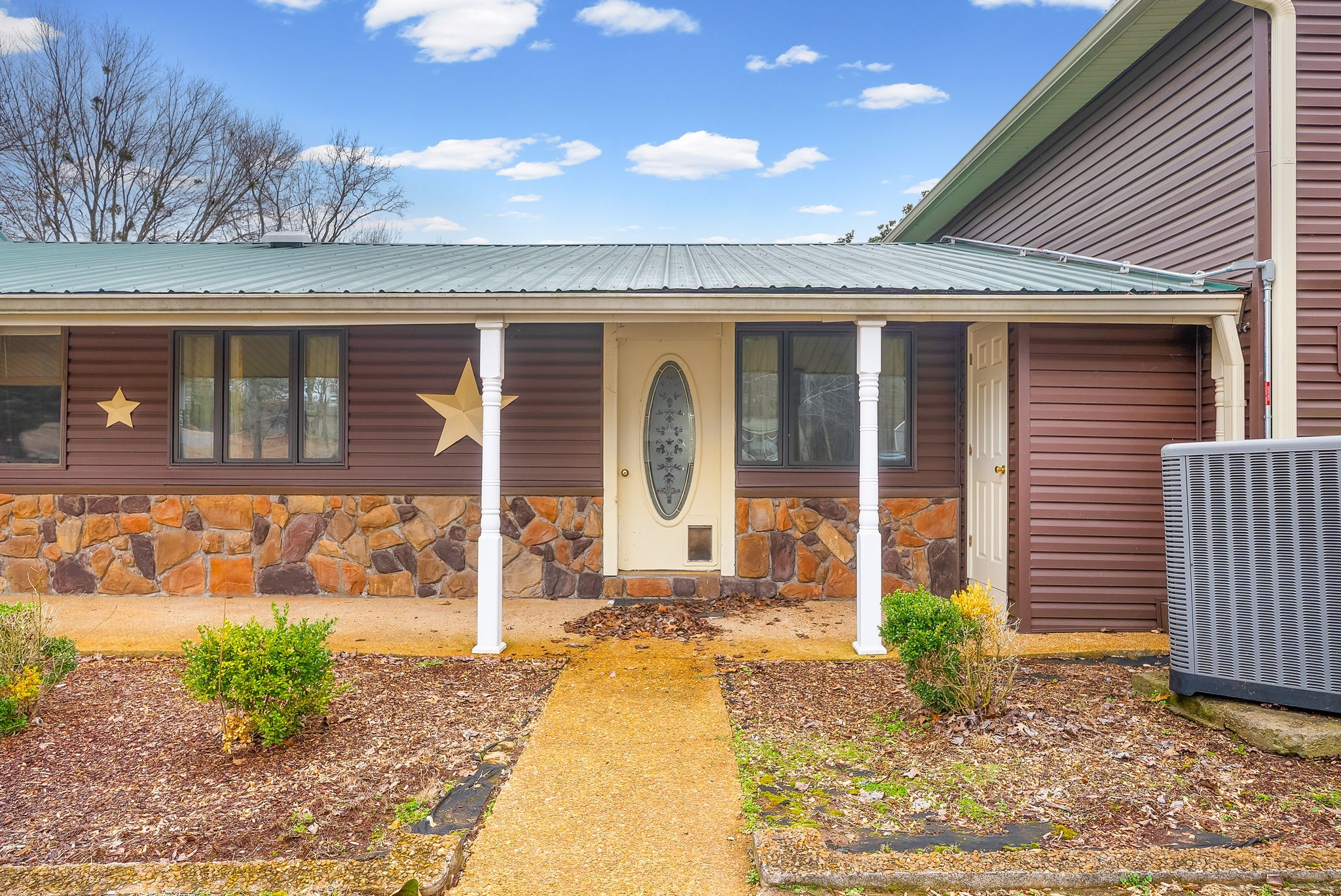 369 Holiday Acres Drive Springville, TN 38256 - Photo 7 of 100 a front view of a house with garden