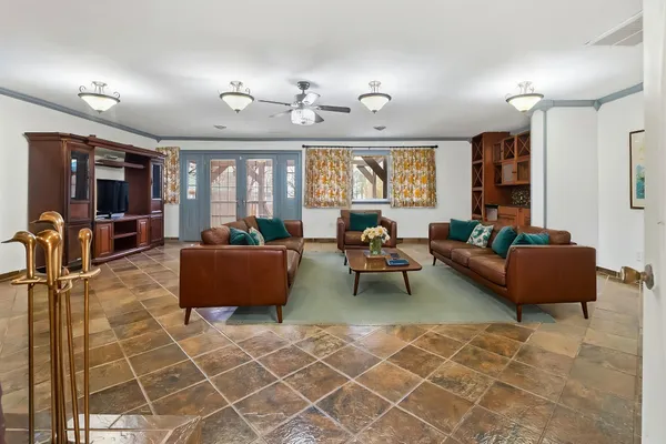 a view of a livingroom with wooden floor and stairs