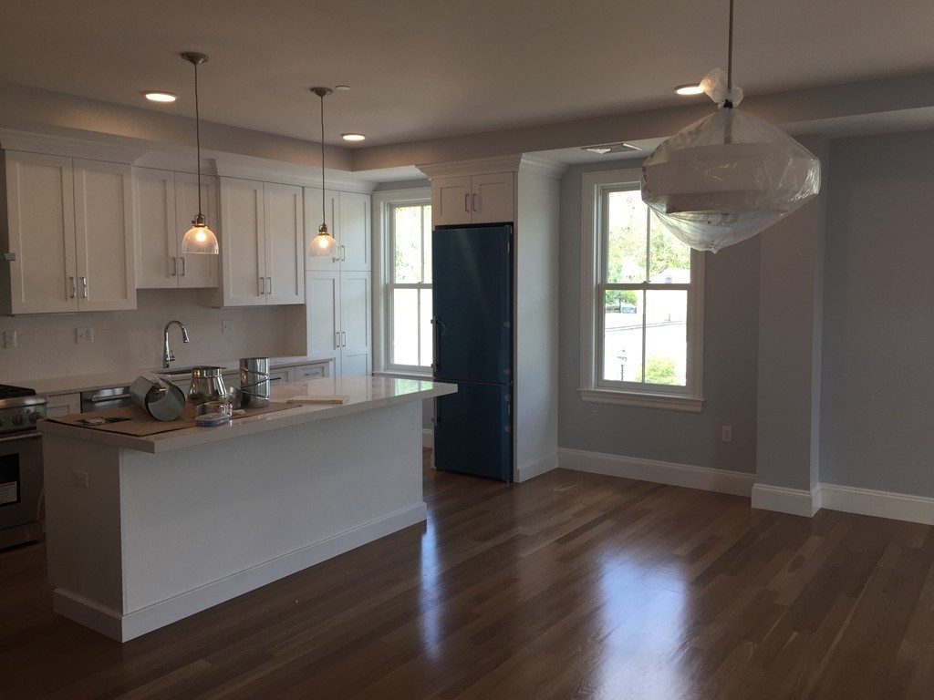 55 South Street, Unit 301 Hingham, MA 02043 - Photo 1 of 1 a kitchen with granite countertop a stove a sink a refrigerator and cabinets