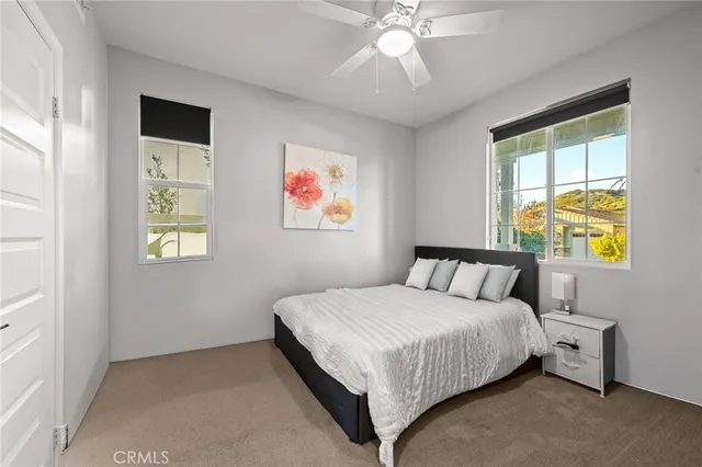 a bedroom with a bed and a painting on the wall