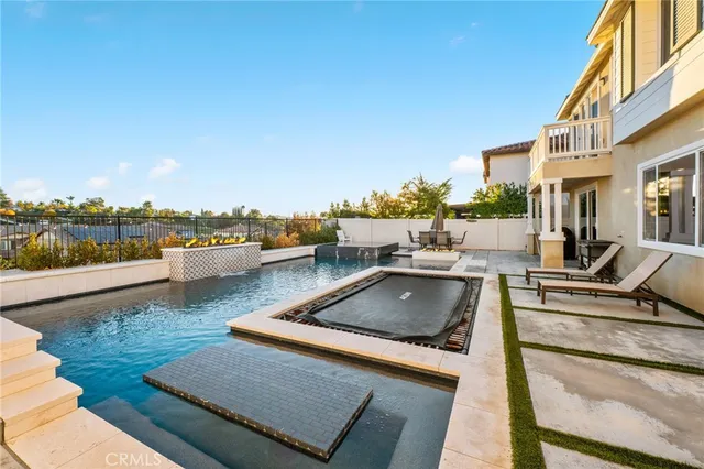 a view of a house with pool and chairs
