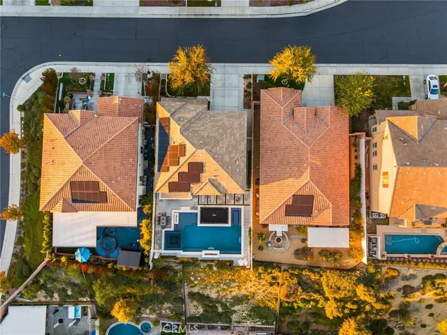 a view of a pool with a table and chairs